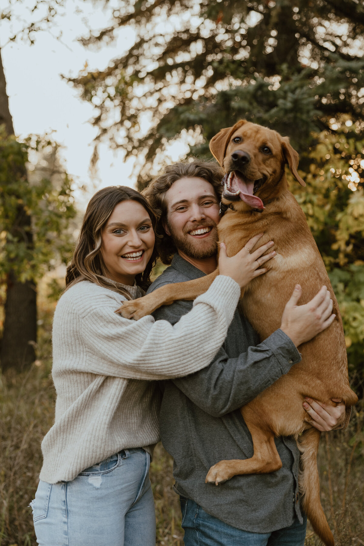 dog with engaged couple