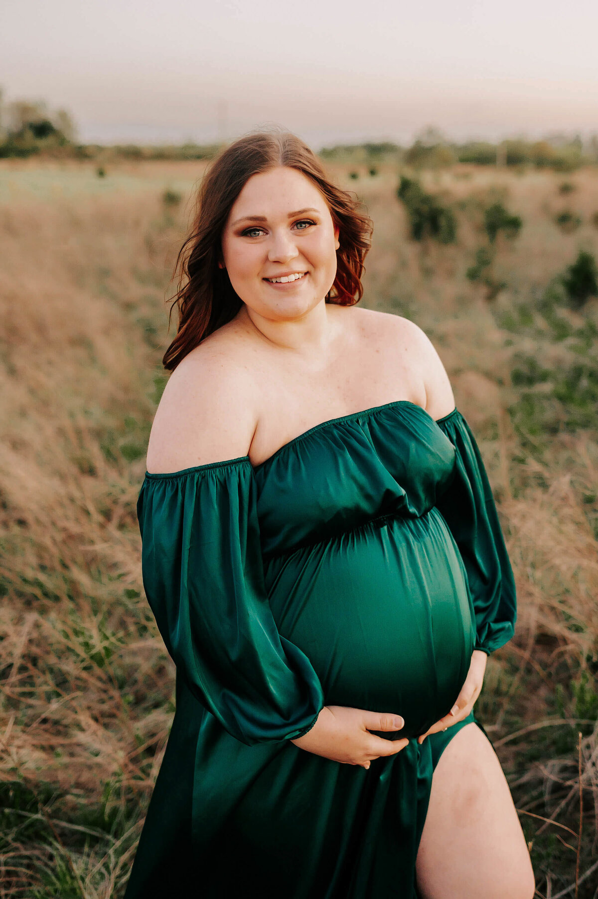 pregnant mom smiling and enjoying maternity photographer in  Branson