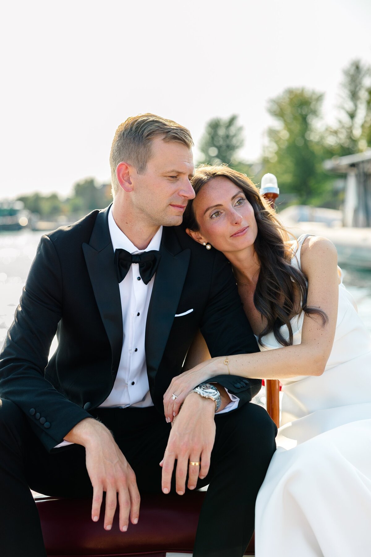 Bride and groom on a wooden boat enjoying a quiet moment together