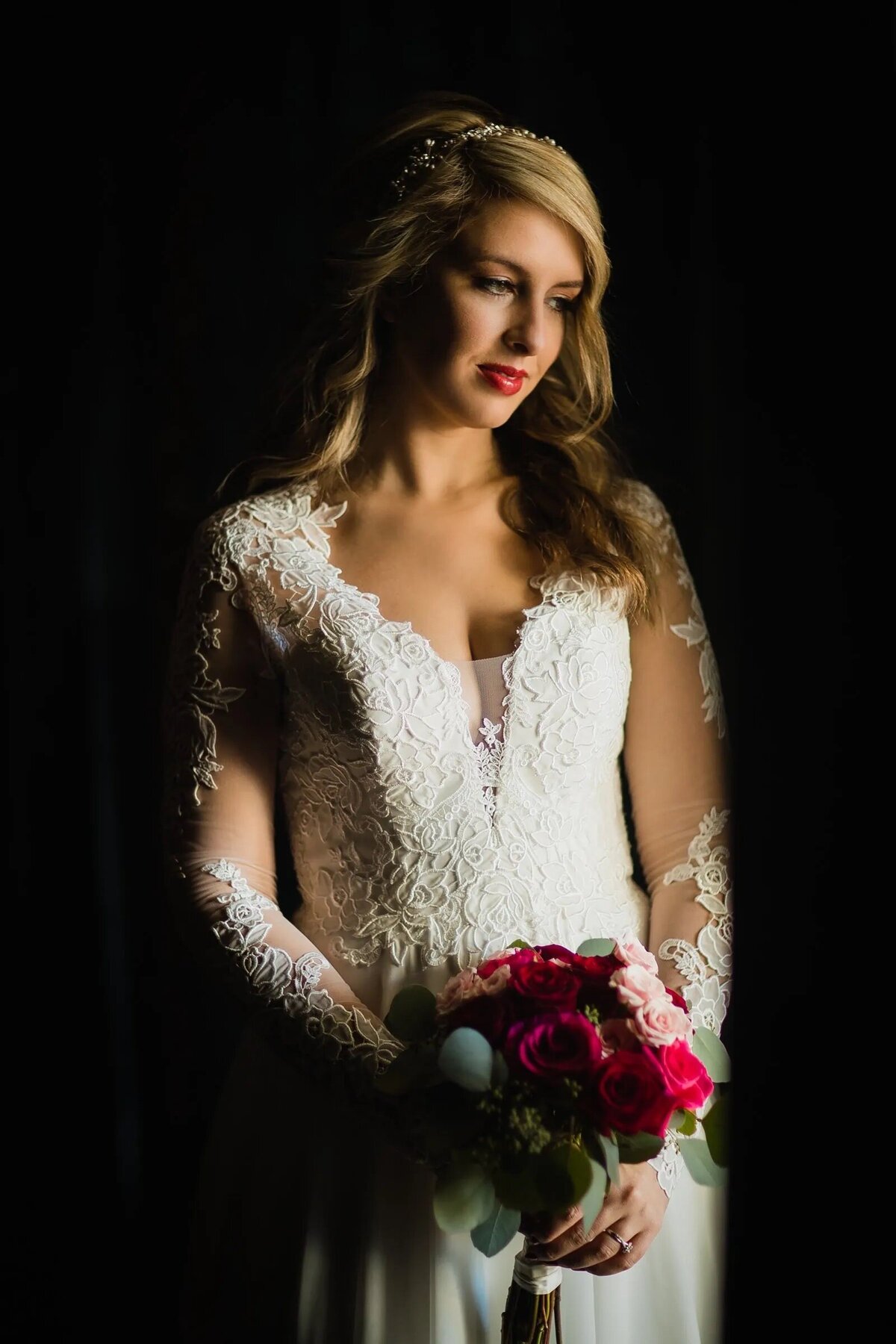A bride holding a bouquet and looking down
