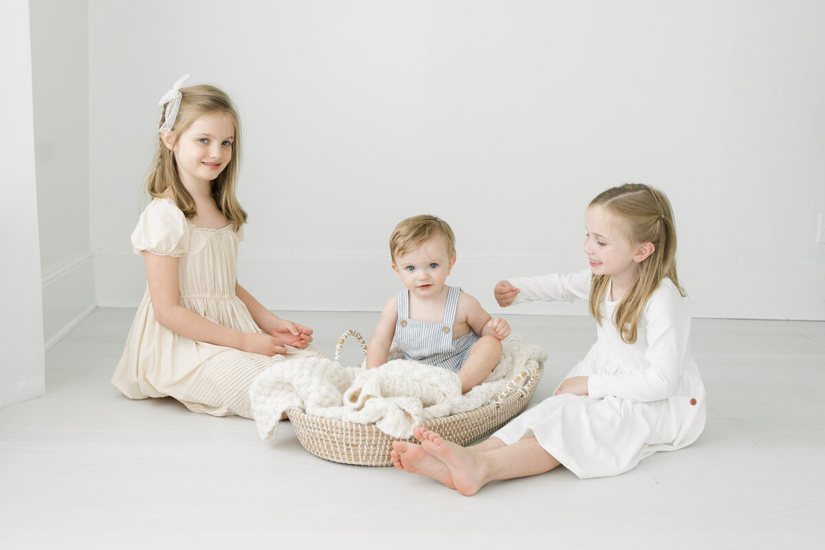 three siblings sitting together