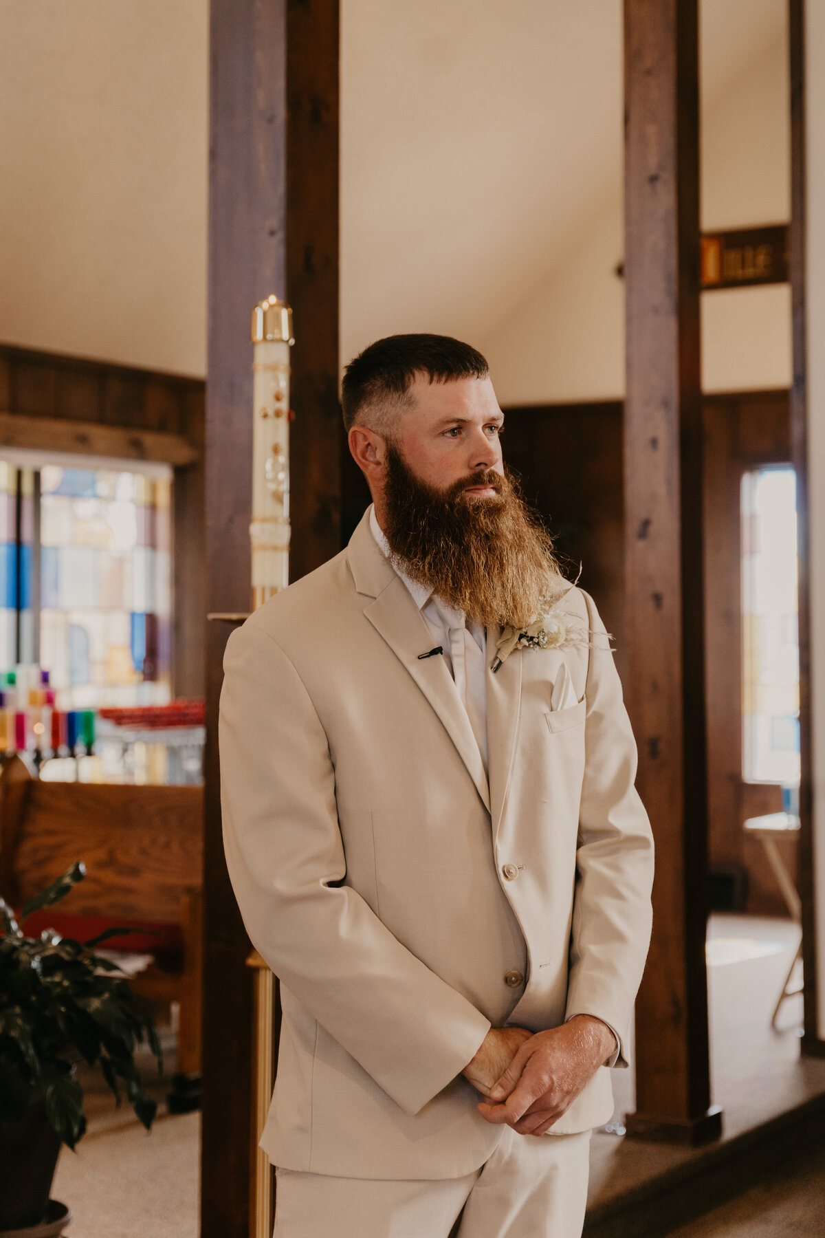 Groom standing at Catholic Church alter waiting for Bride.