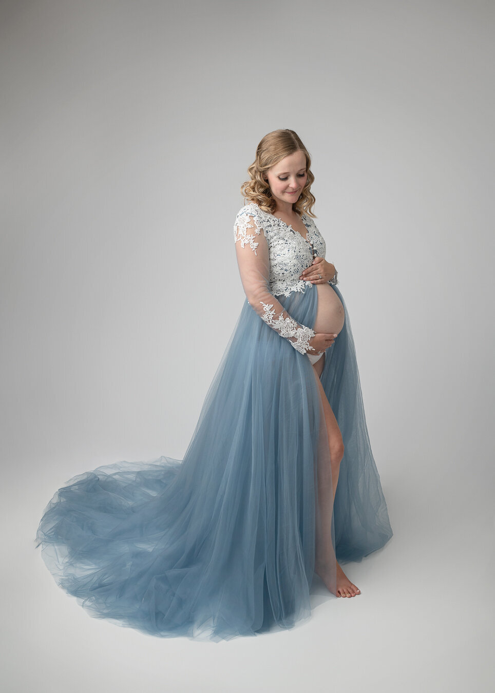 fine-art maternity portrait of woman in blue gown
