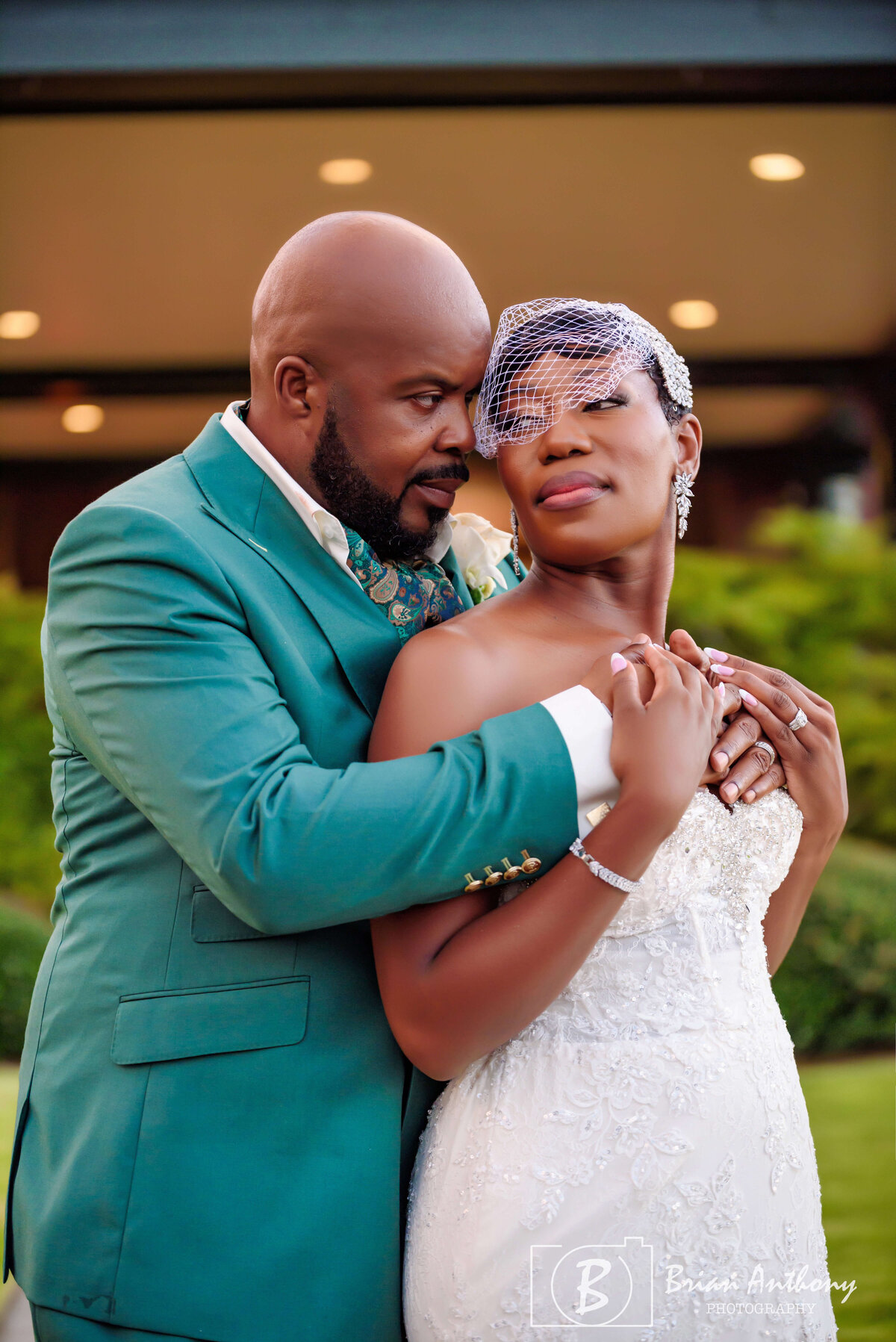 Emotional moment as the groom embraces his bride in a heartfelt wedding portrait.