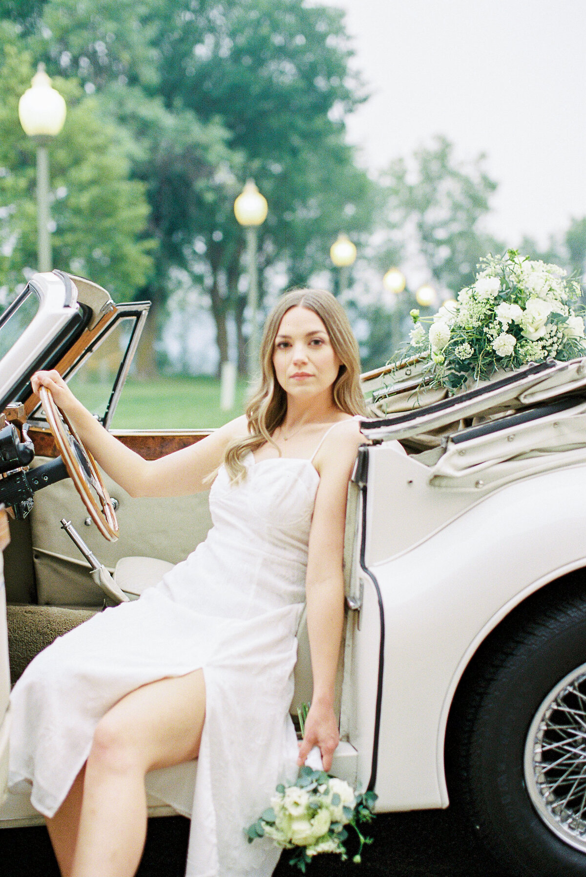 bride sitting in vintage jaguar