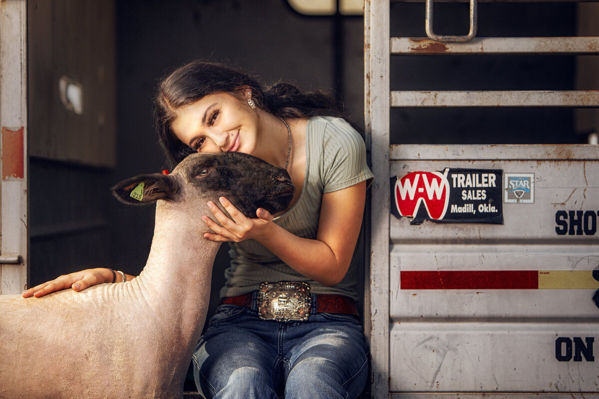 girl with lamb in trailer