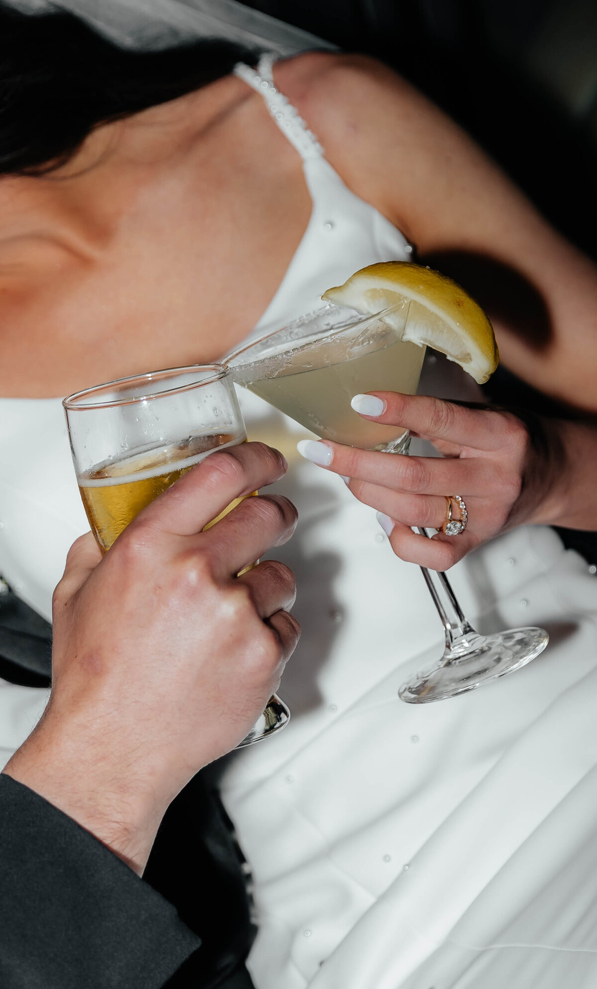 Champagne and cocktail cheers at reception, documentary-style wedding photography capturing lively, personal celebration moments in Michigan