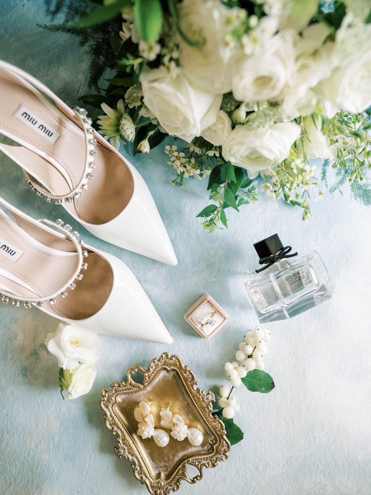 Flat lay of wedding shoes and wedding accessories