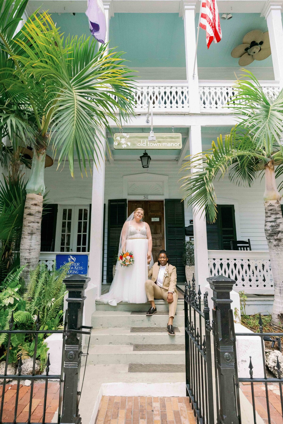 Two brides pose in front of Old Town Manor for their Key West Wedding