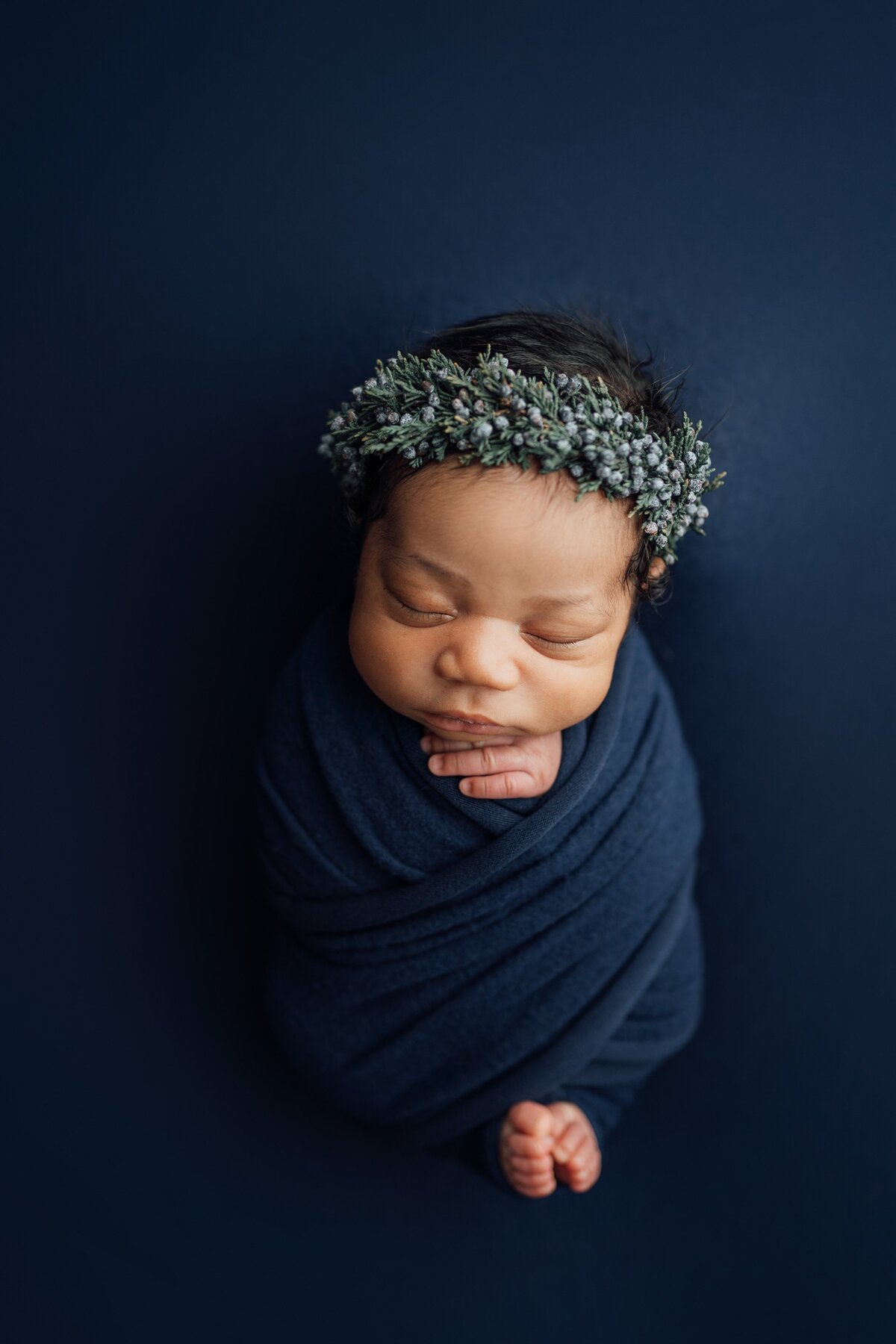 baby girl on navy posed at newborn photography session in Tampa