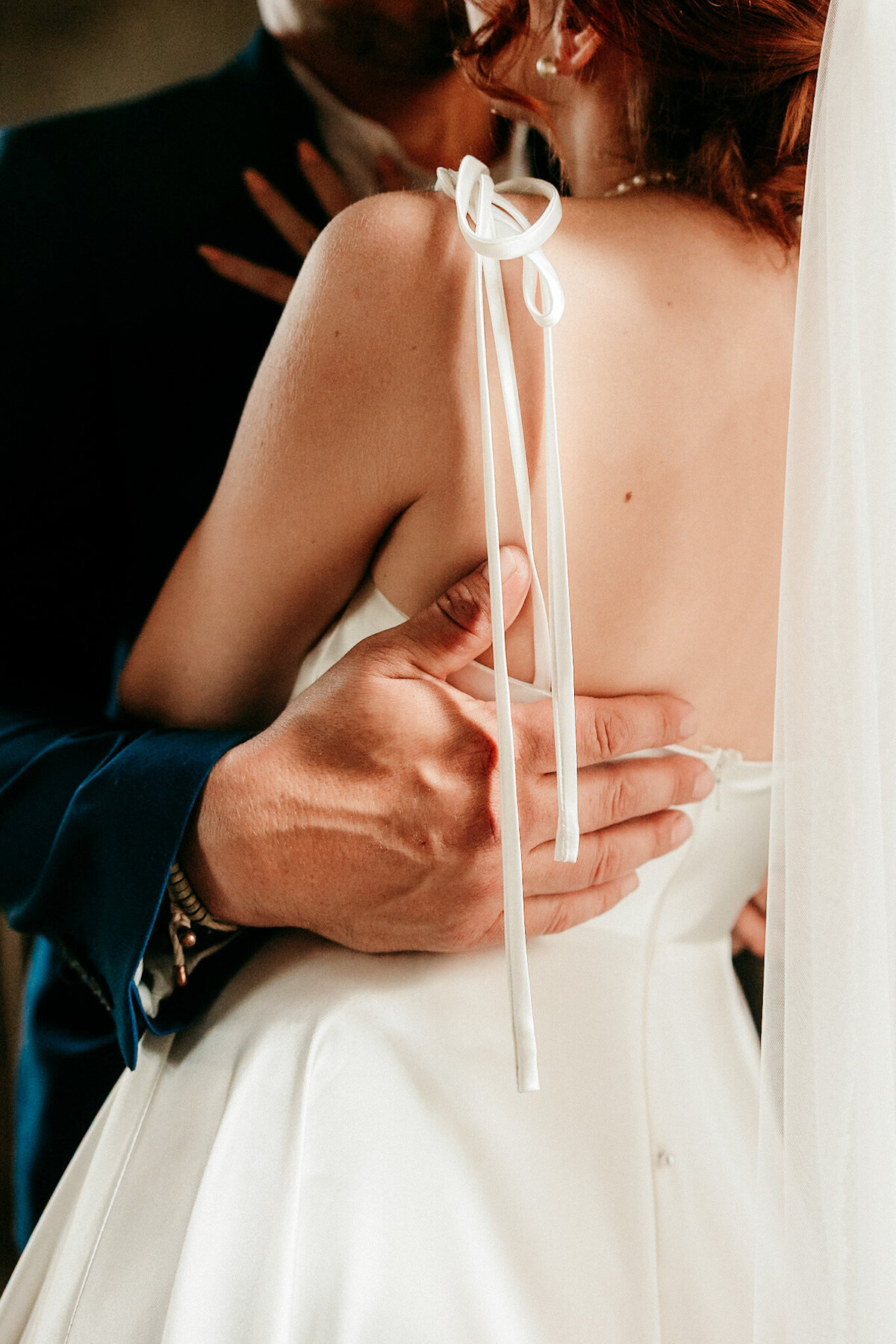 Close-up of bride and groom holding each other lovingly during their St. Augustine wedding.