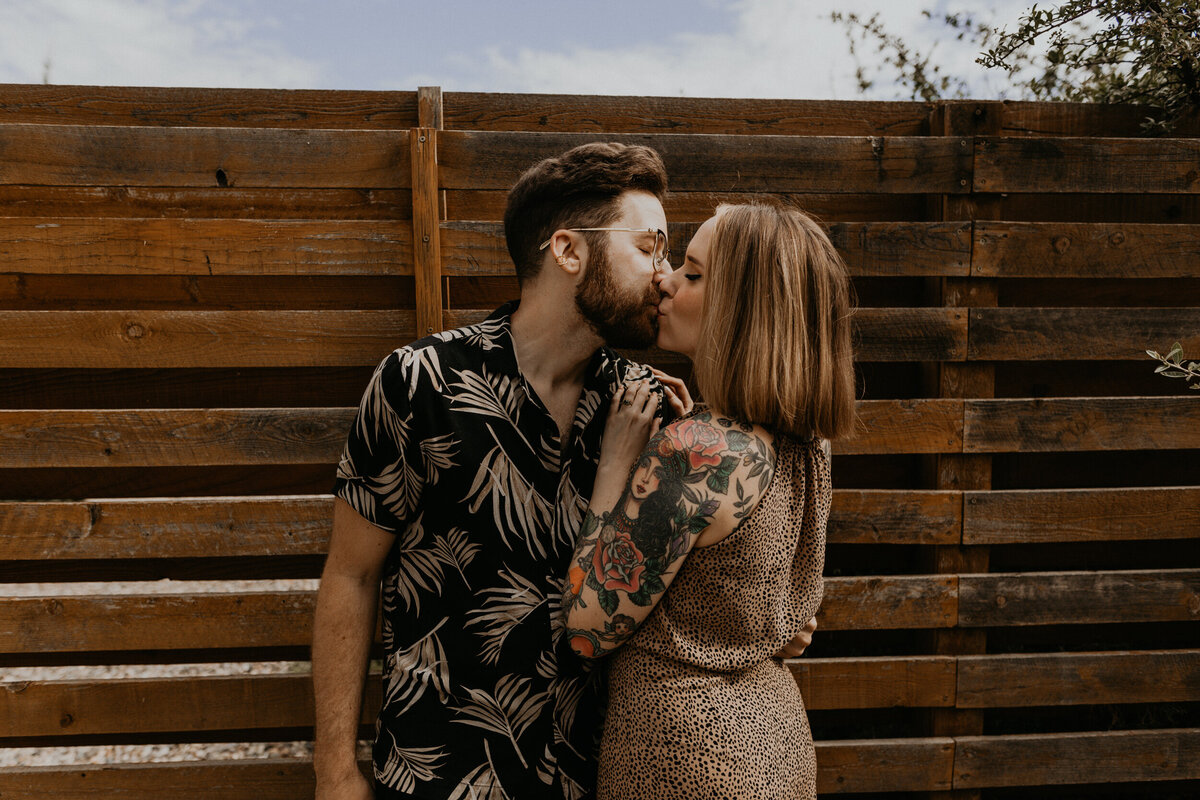 engaged couple smoking weed on porch together laughing