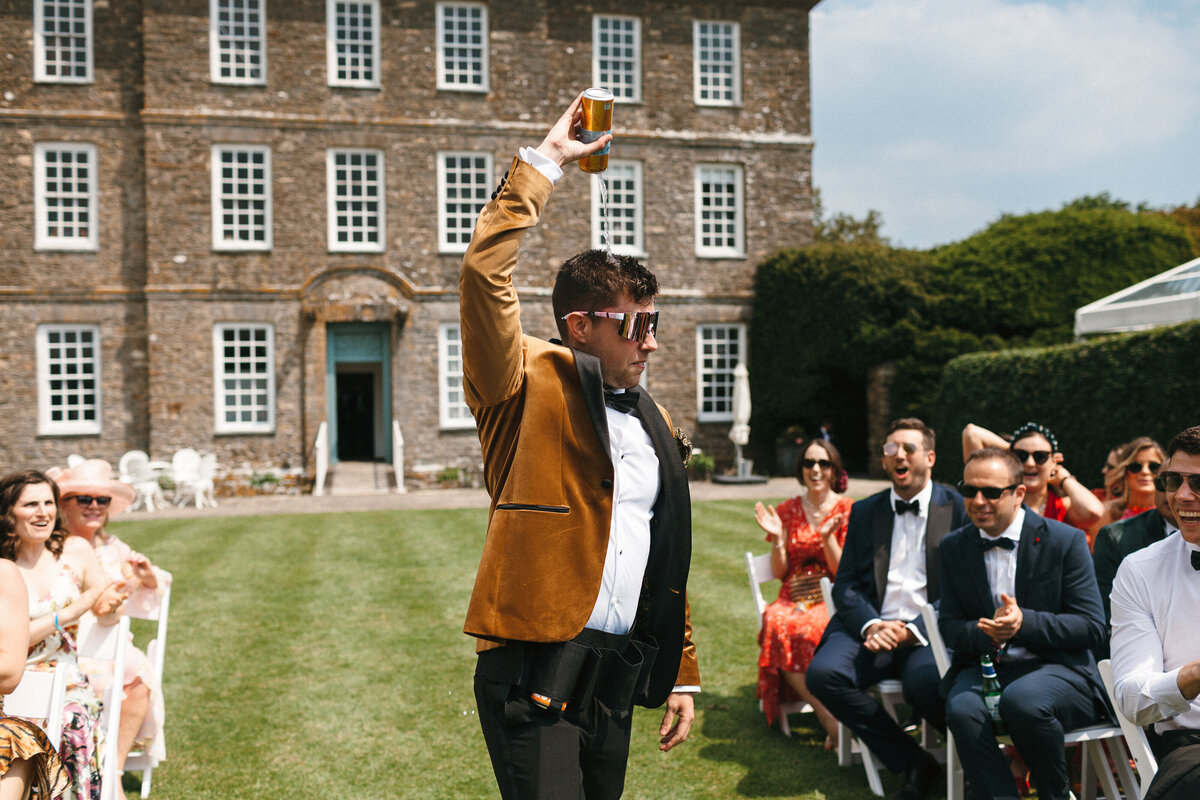 Beer boy pours beer onto his head whilst walking down the aisle
