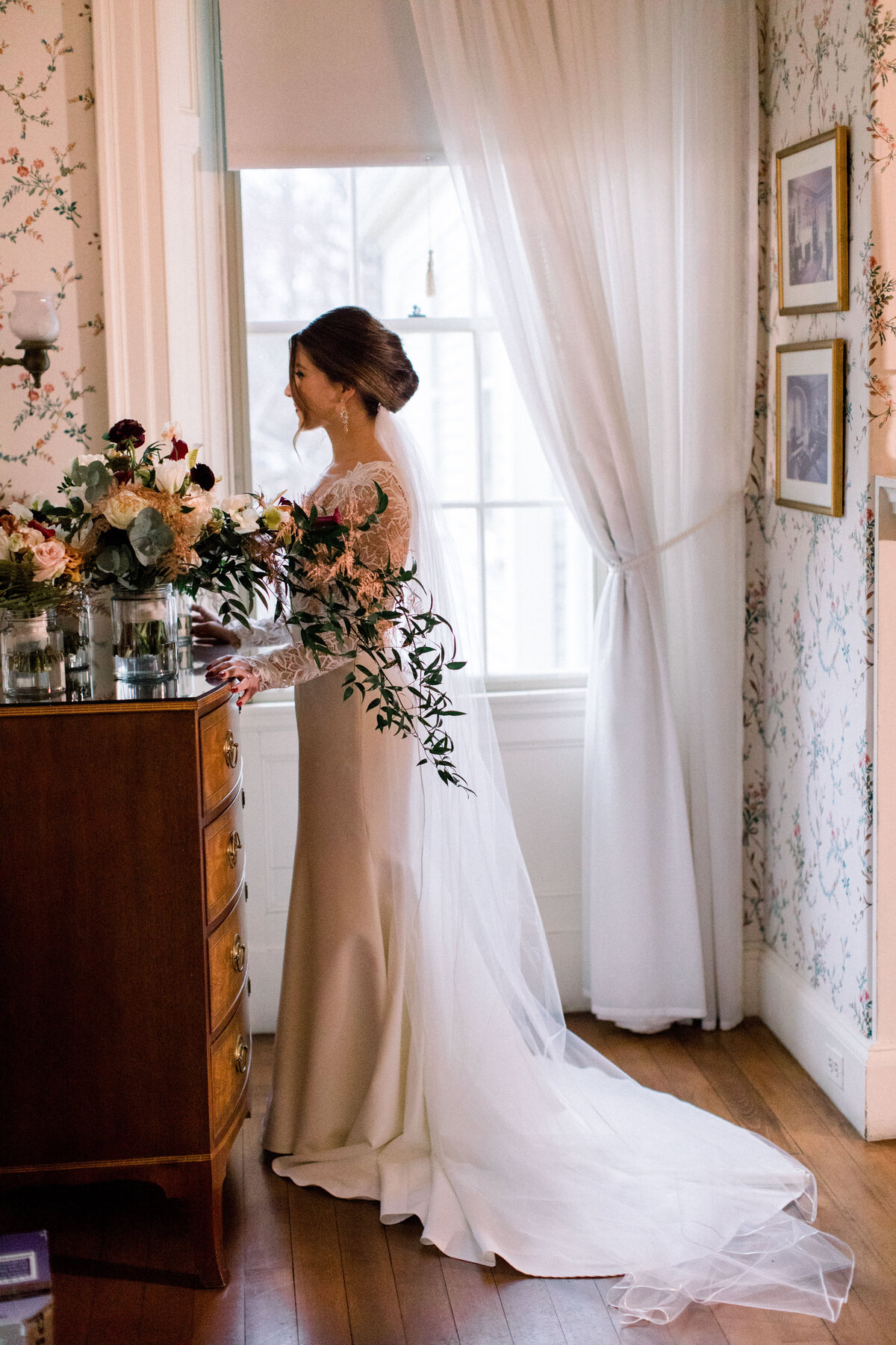 Bride standing by window at Lyman Estate