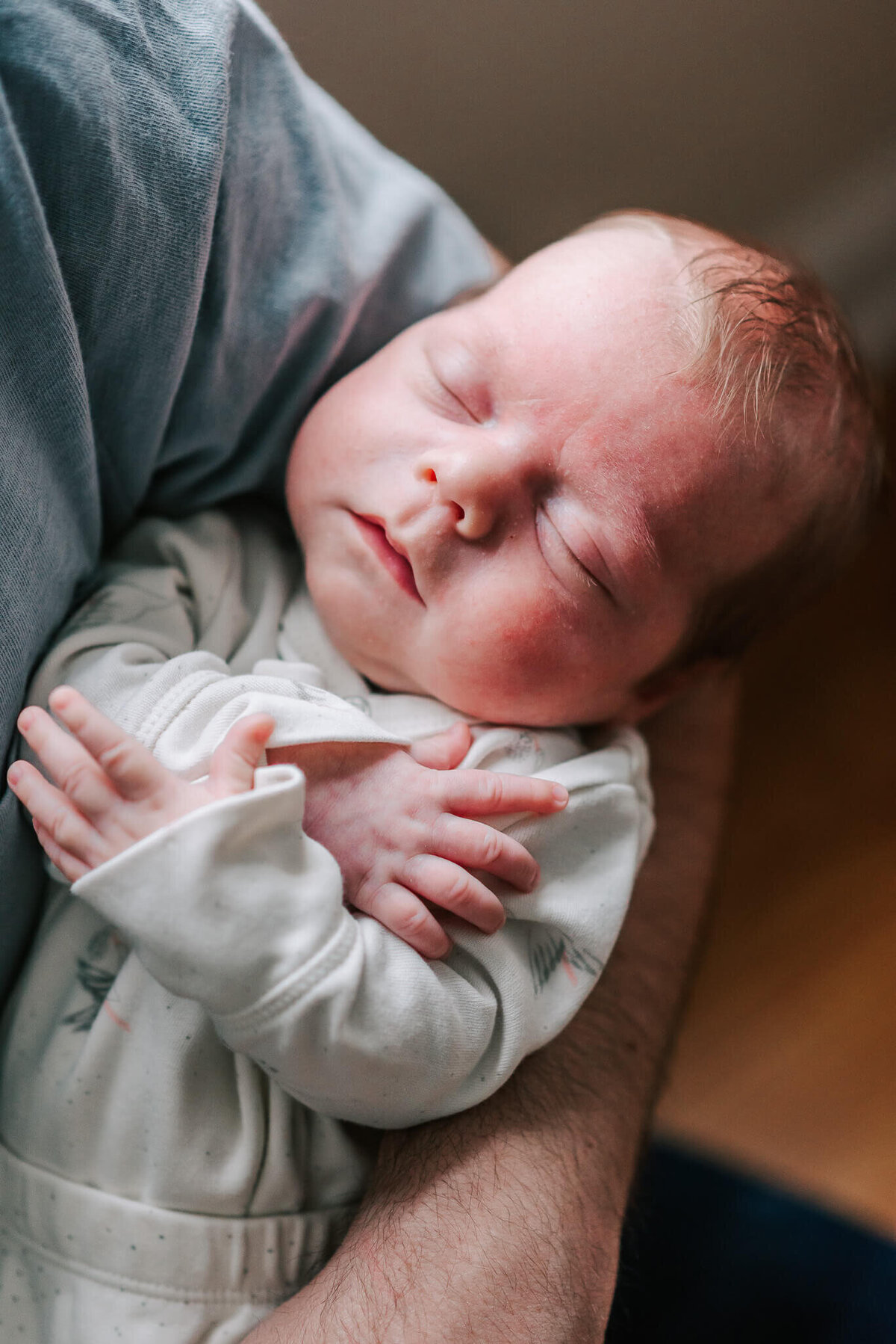 closeup of a sleeping redheaded newborn boy