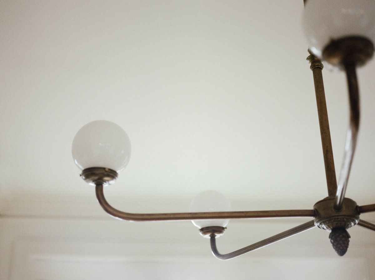 antique, vintage simple chandelier, lighting, clean white space at ALEO Detroit, Little Village