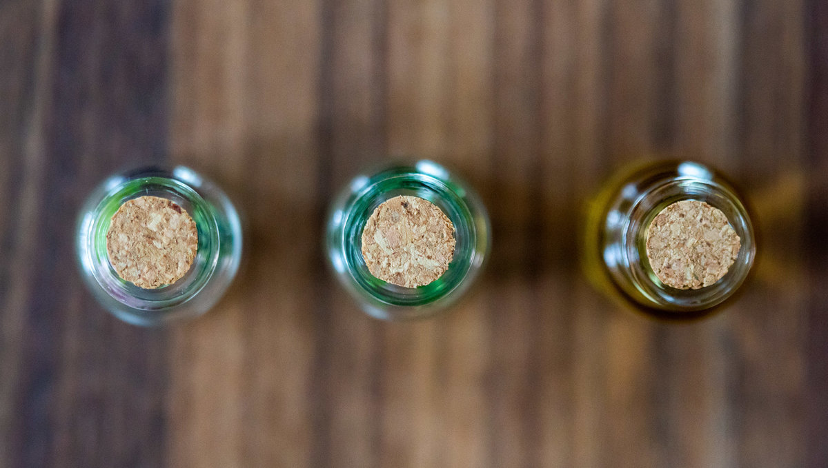 A close up of the lids of 3 small vials part of a keepsake wedding box.