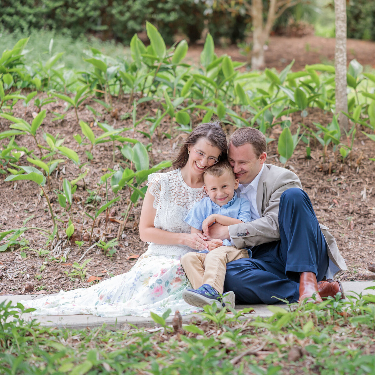 family-of-three-under-trees