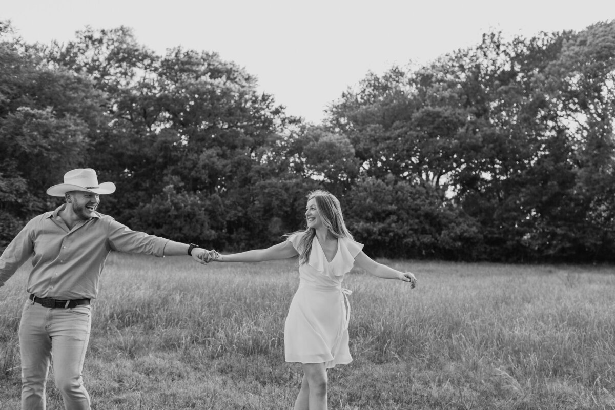 Playful engagement session in a field at Airfield Falls captured by Fort Worth Wedding Photographer, Megan Christine Studio