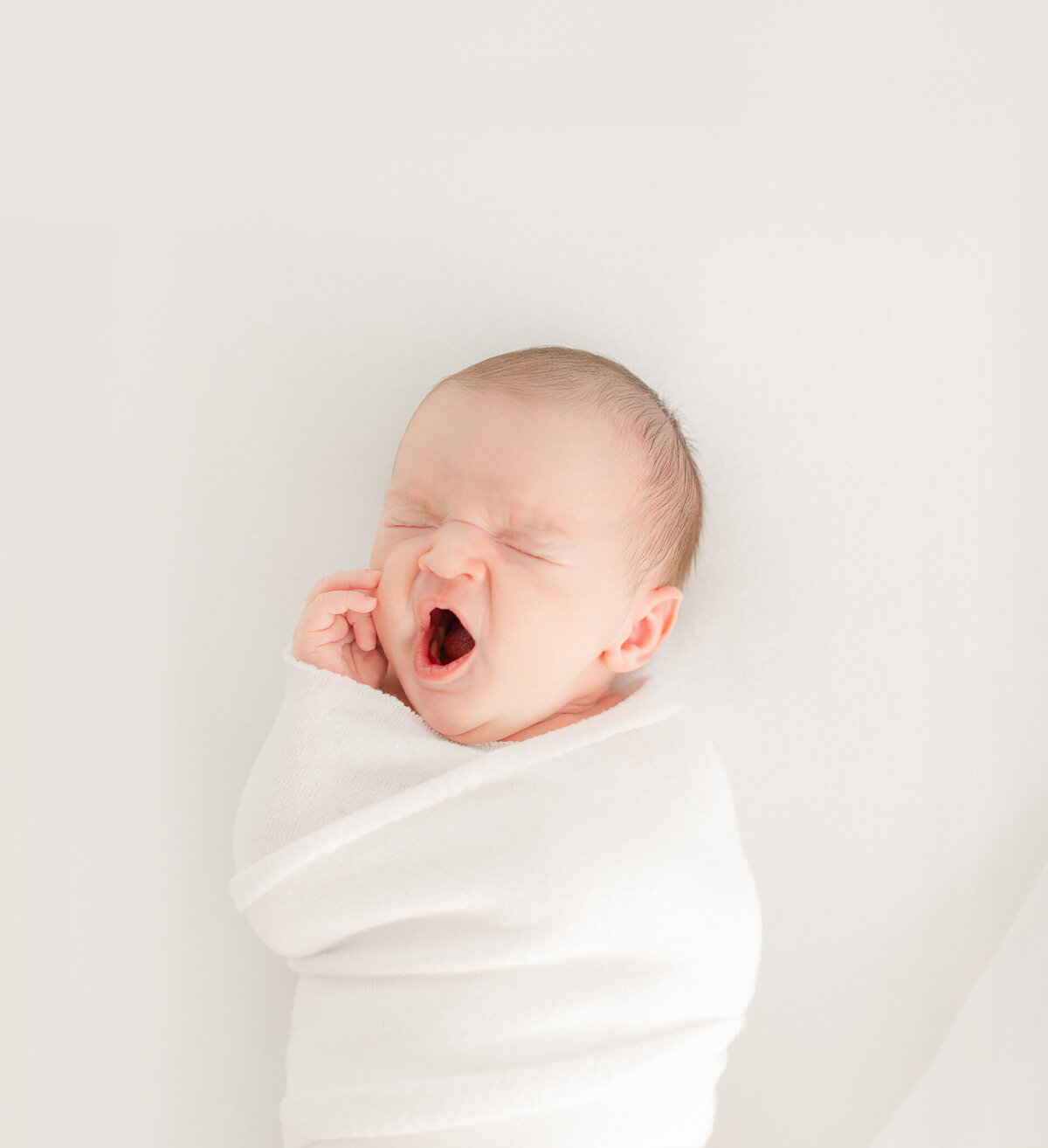 yawning baby during boston newborn photoshoot