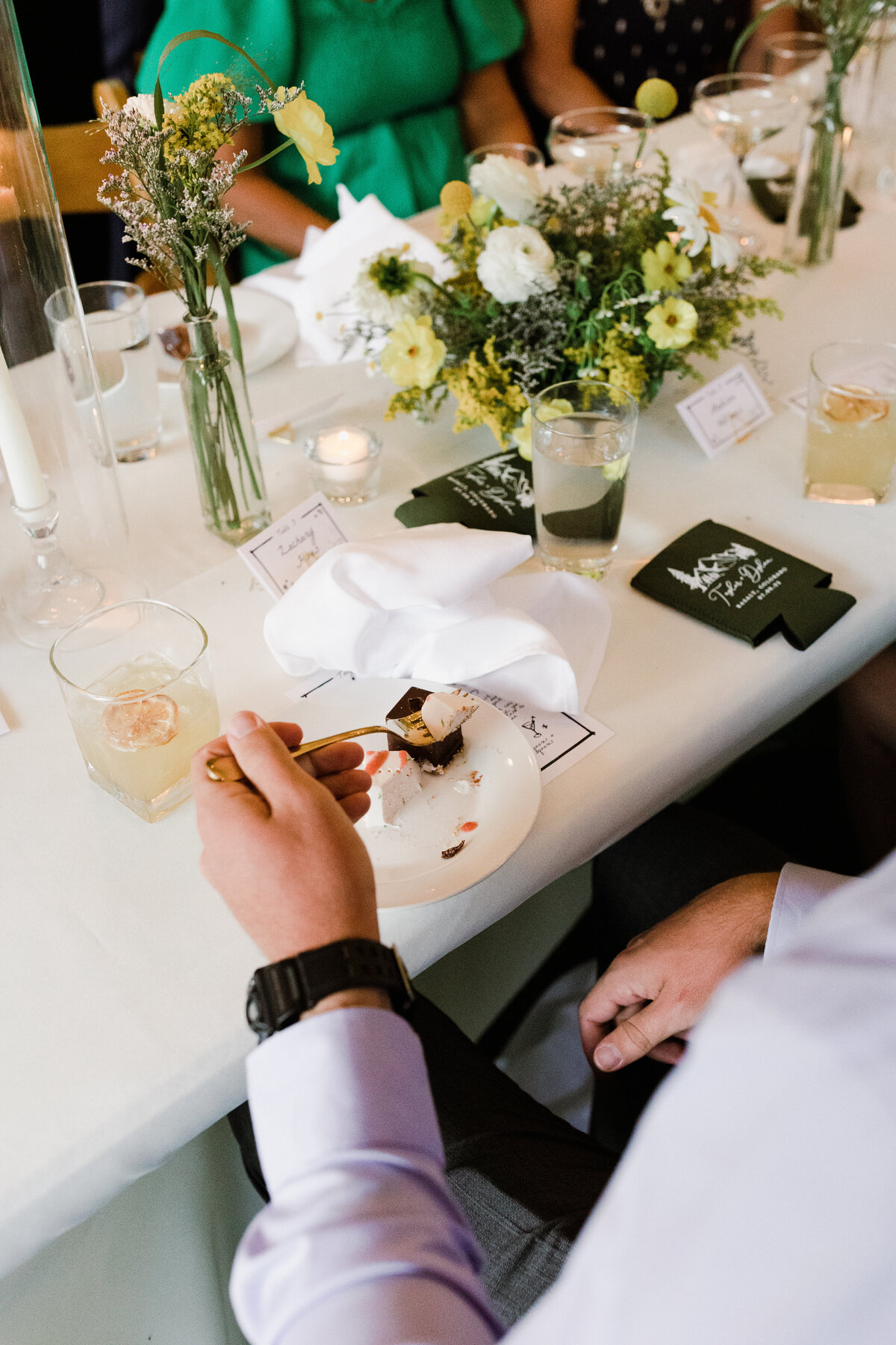Man sitting at table eating wedding cake