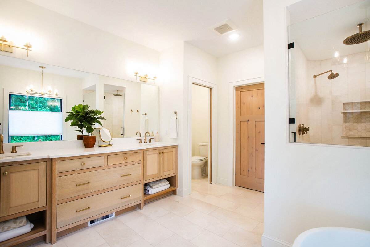 Custom bathroom with soaking tub, double vanity, and walk-in shower in Otsego custom home