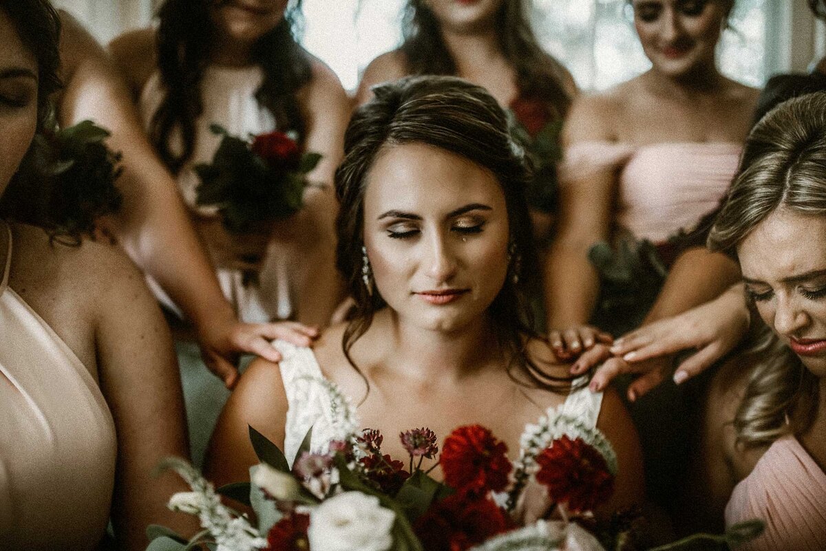 bride-praying-with-bridesmaids-while-crying-journalistic-wedding-photography-missouri
