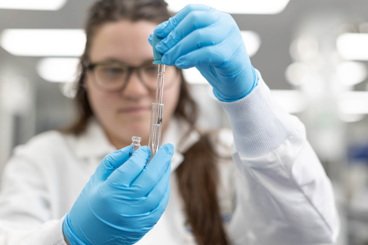 Scientist dropping liquid into a test tube
