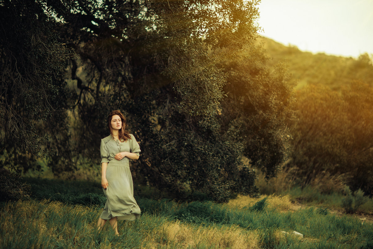 Portrait Photo Of Young Woman In Holding Her Waist While Looking Up At The Sky Los Angeles