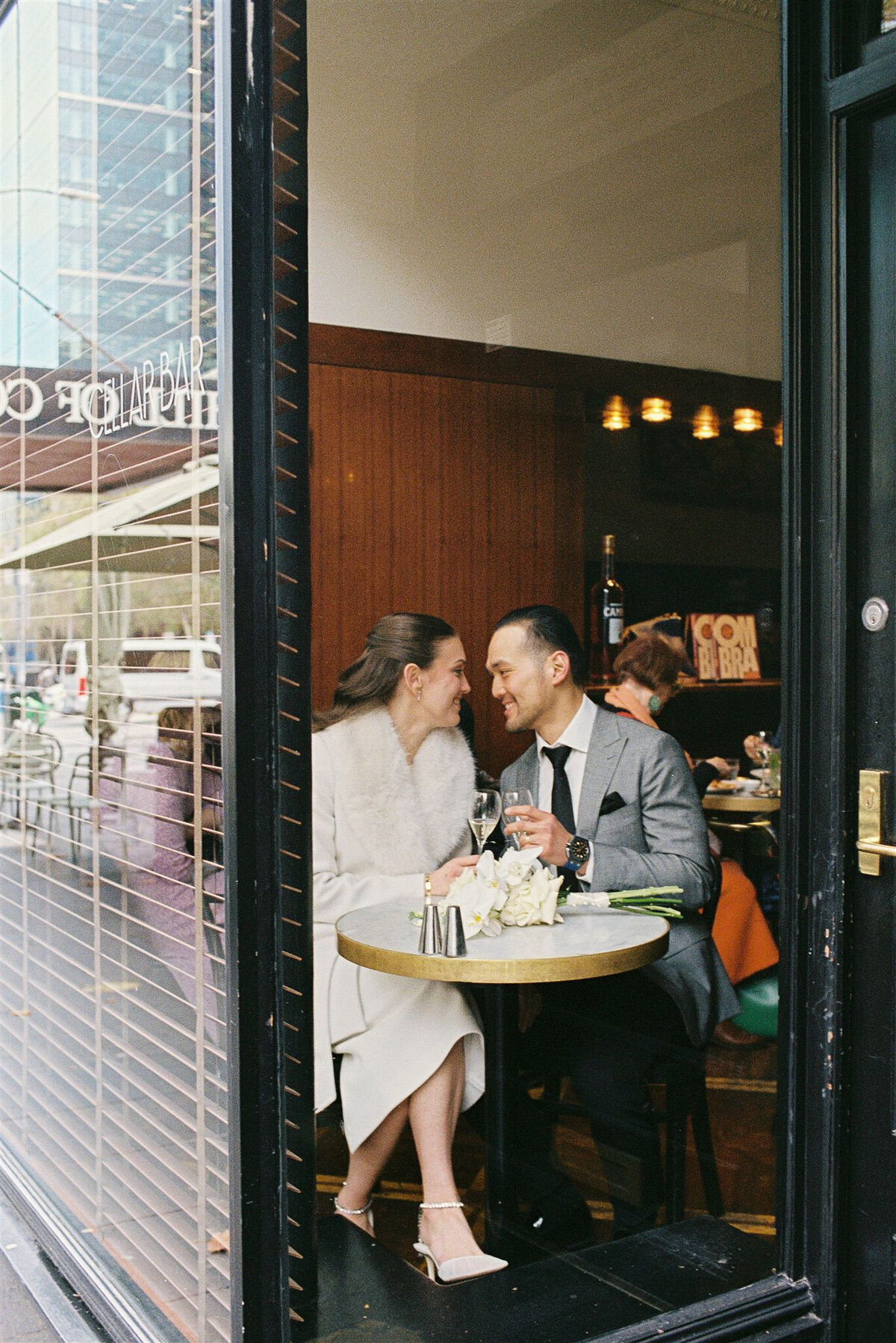 Couple enjoying a relaxed drink together in the cozy cellar bar in Melbourne, captured candidly on 35mm film.