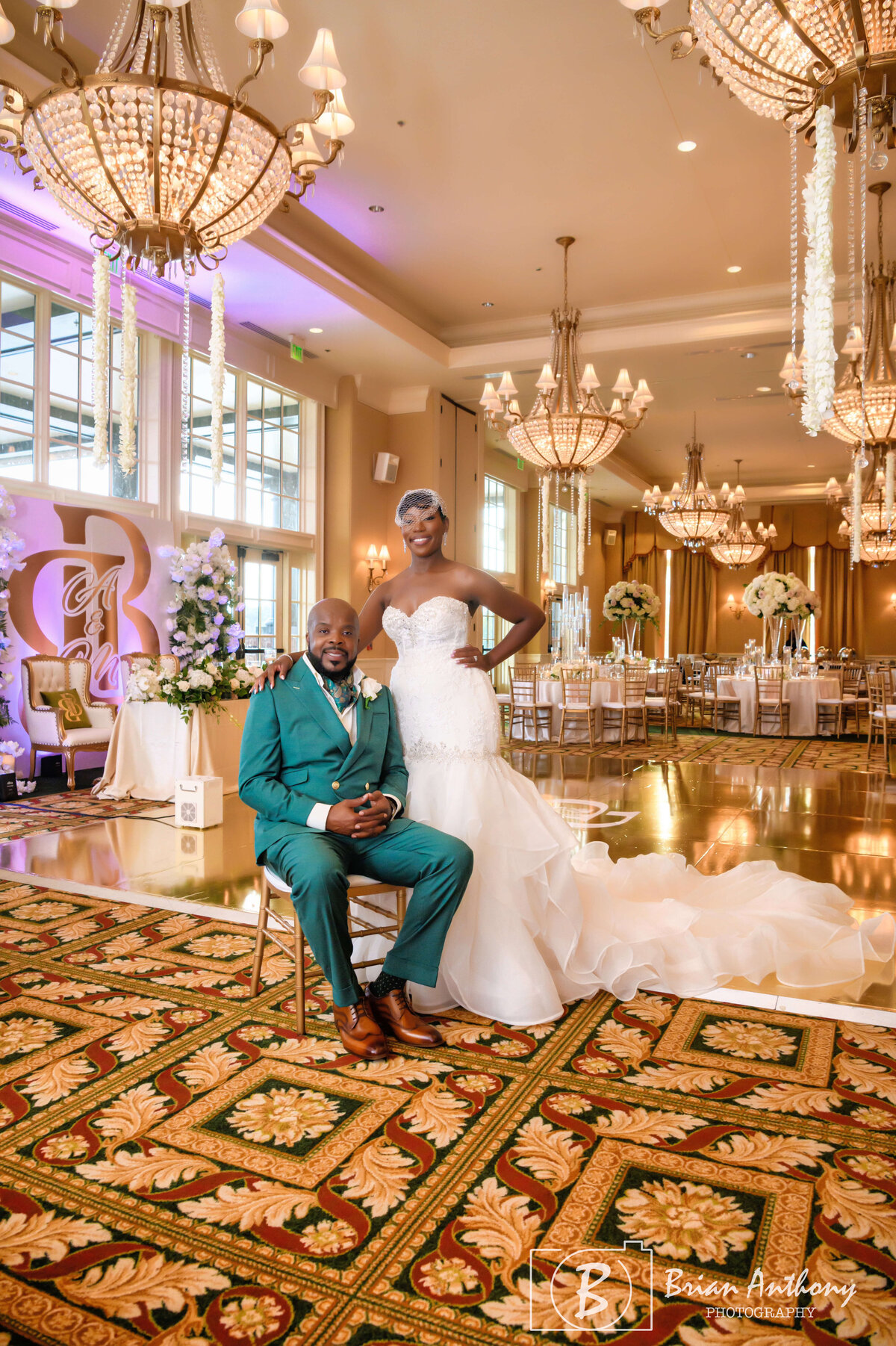 Stylish groom posing in an opulent wedding venue, ready for the big day.