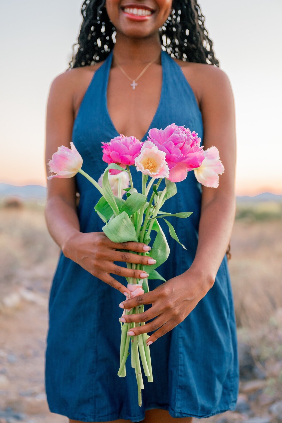 senior girl holding flowers in the arizona desert 