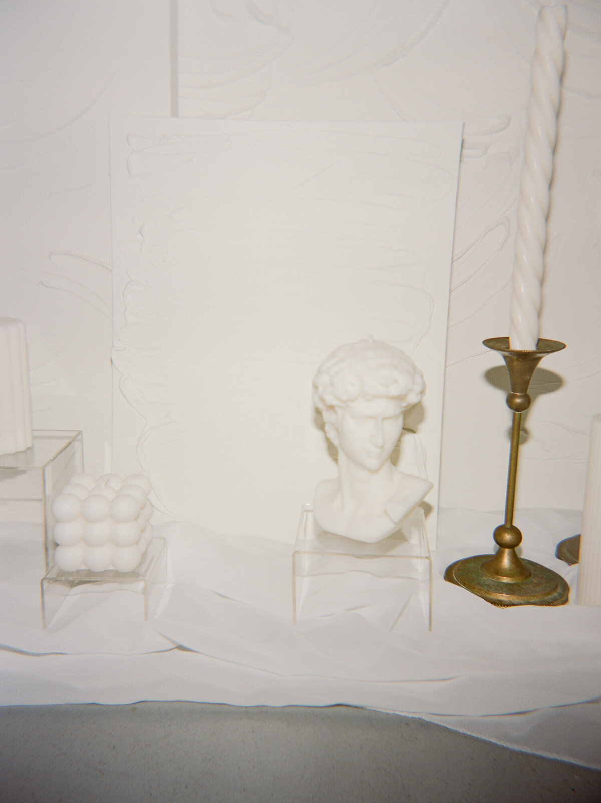 sculpture bust head candle, gold candlesticks, white space for florist branding photos
