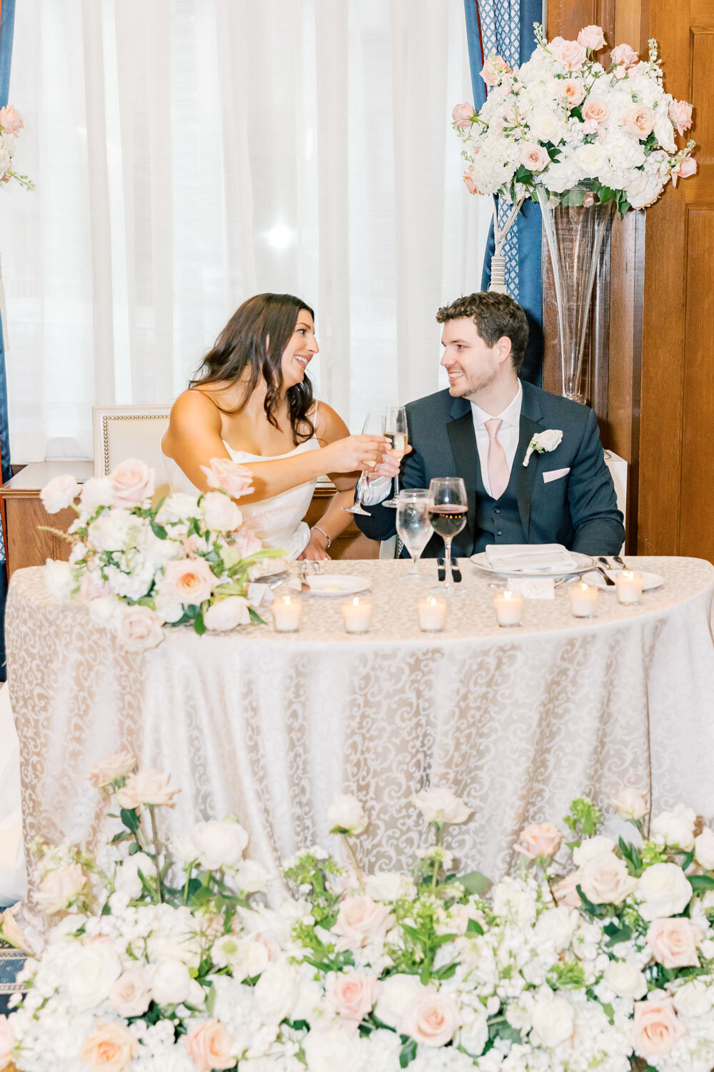 Bride and groom toast at sweetheart table