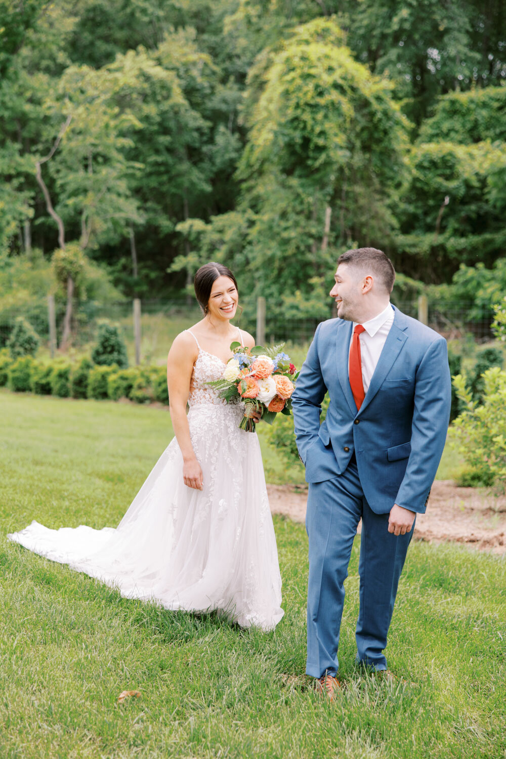 Bride smiling while watching the groom