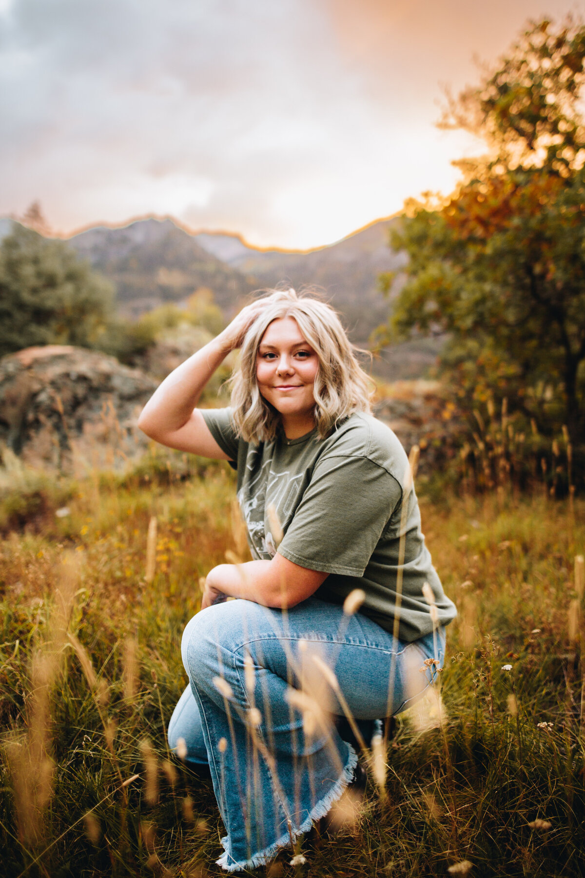 Jewel poses in a field at sunset for her Telluride senior pictures.