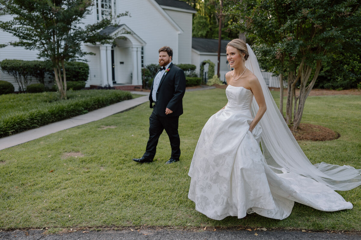 Bride and Groom walk hand in hand surrounded by their bridal party.