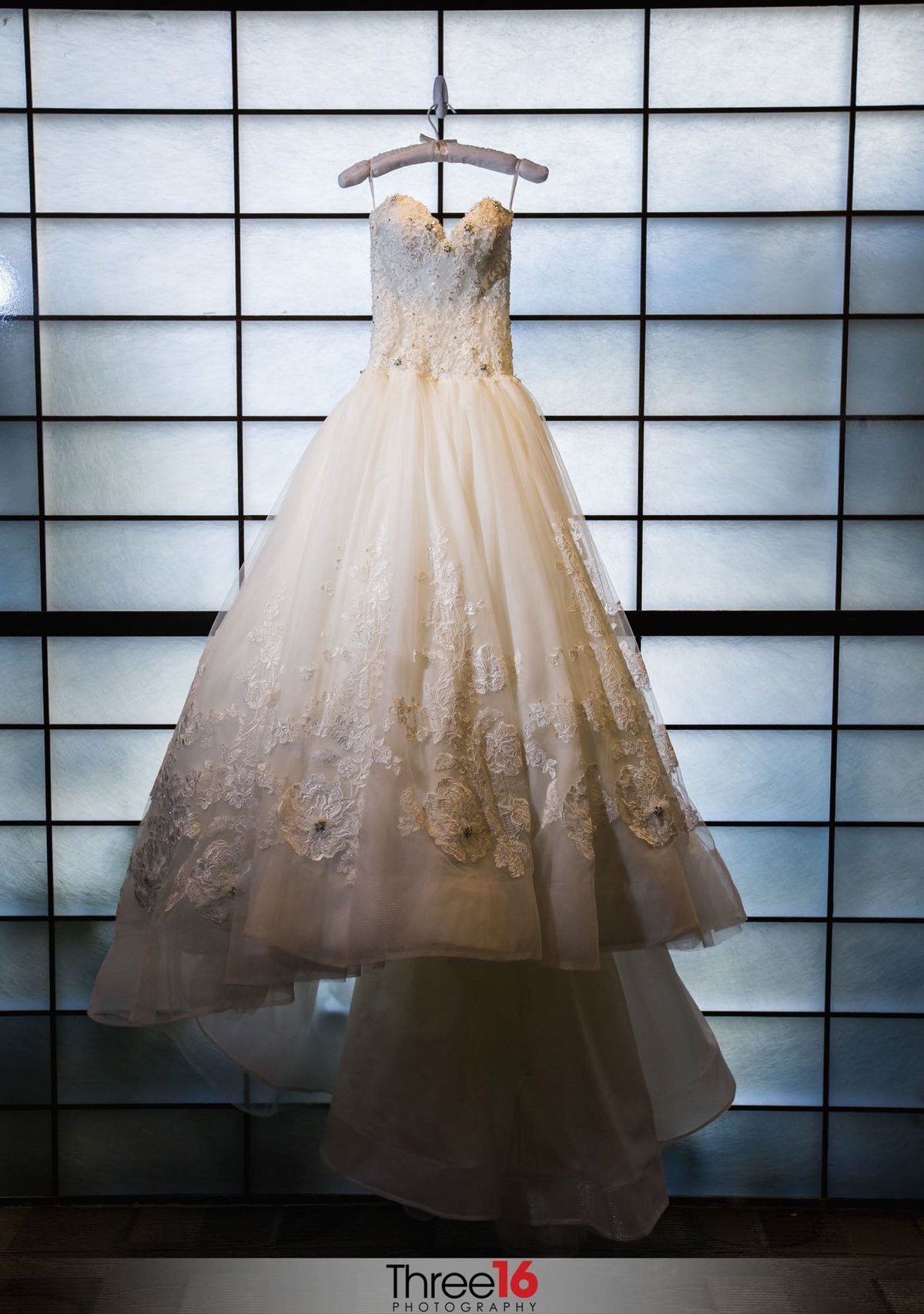Bride's beautiful gown hangs on display