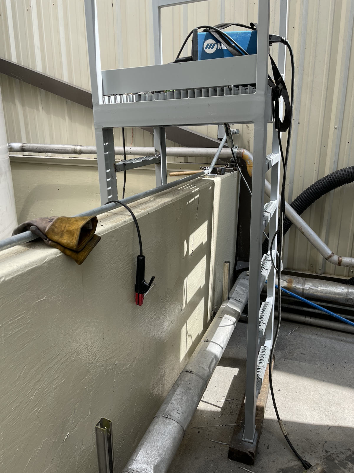 Custom-fabricated welded steel ladder installed for access and safety in an industrial plant facility.