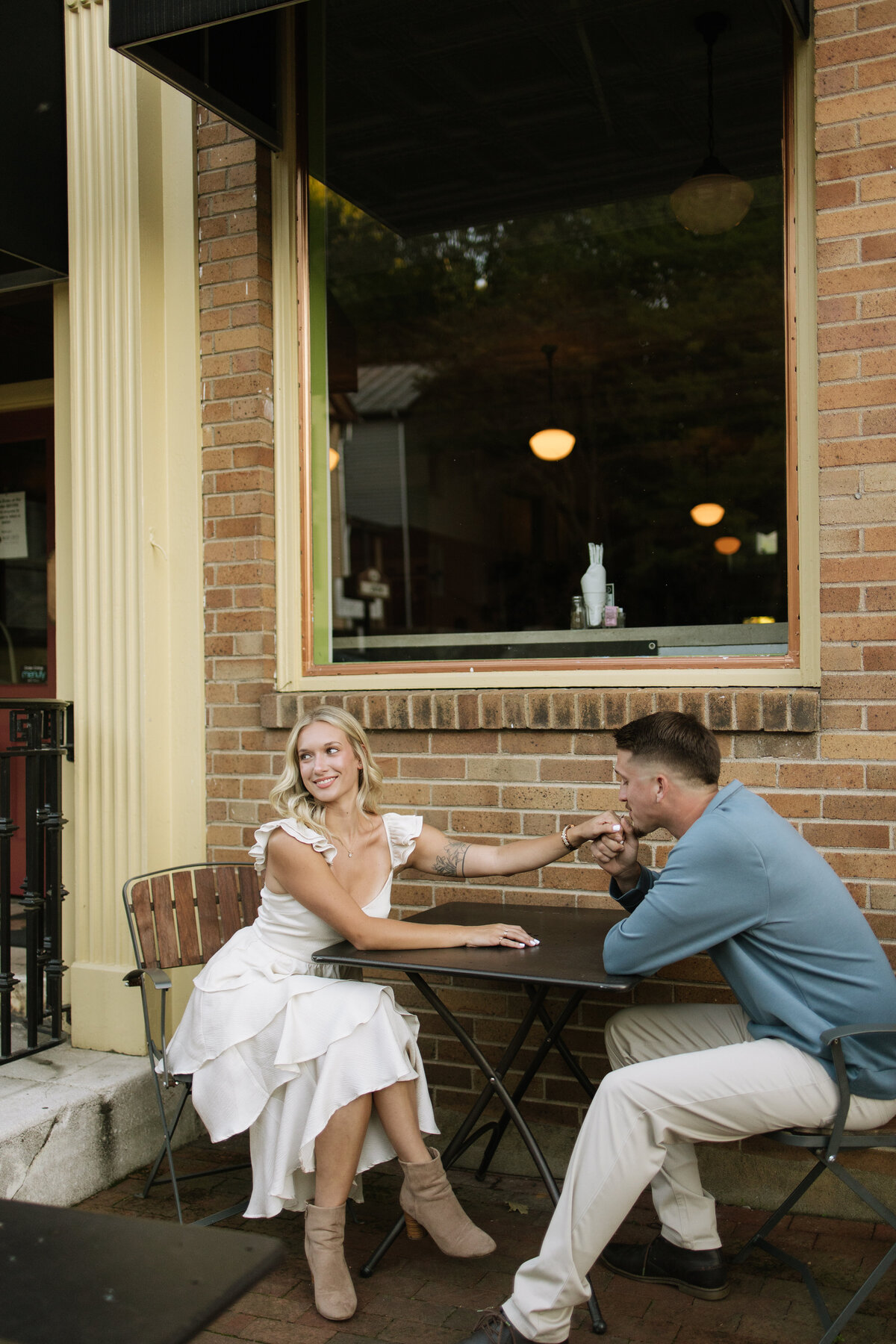 Candid downtown engagement session at a charming Tennessee café