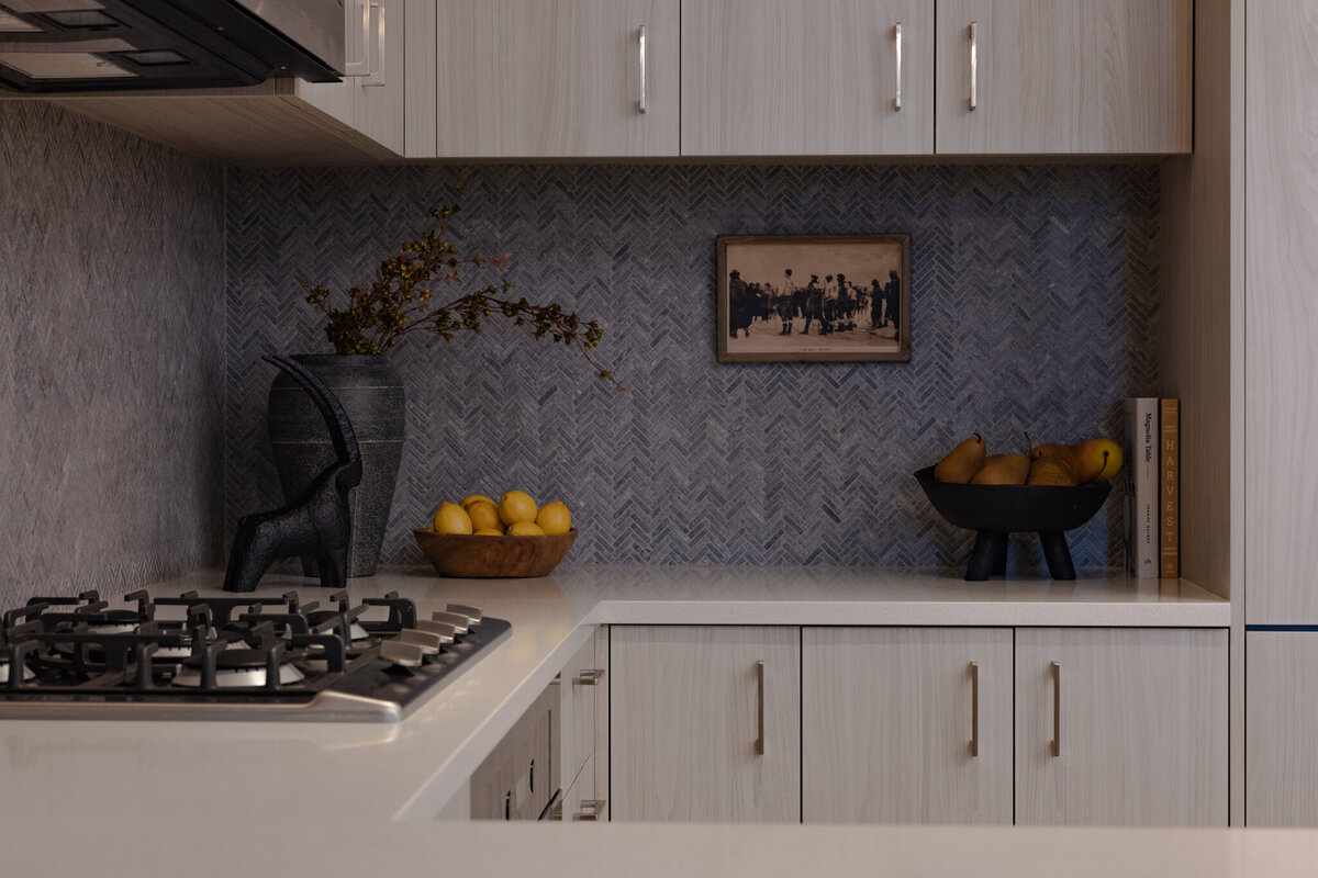 Mountain modern kitchen at the Deer Valley Hyatt Ski Resort in Park City, Utah, featuring a striking blue tile backsplash, custom cabinetry, tailored lighting, and ski-inspired accessories—designed by Valt Interiors in 2024.