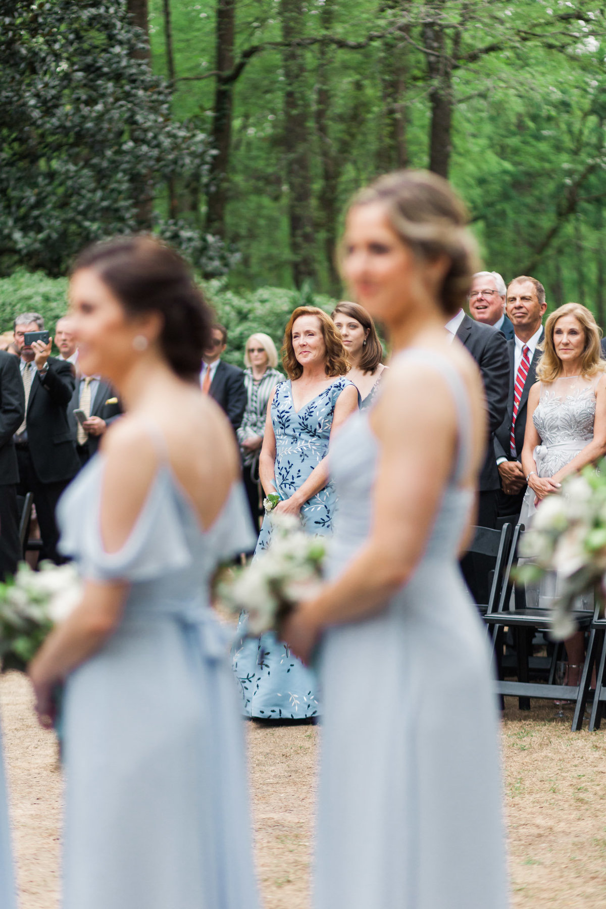 Mother of the bride watches as her daughter walks down the Swan House steps. Photo by luxury destination wedding photographer Rebecca Cerasani.