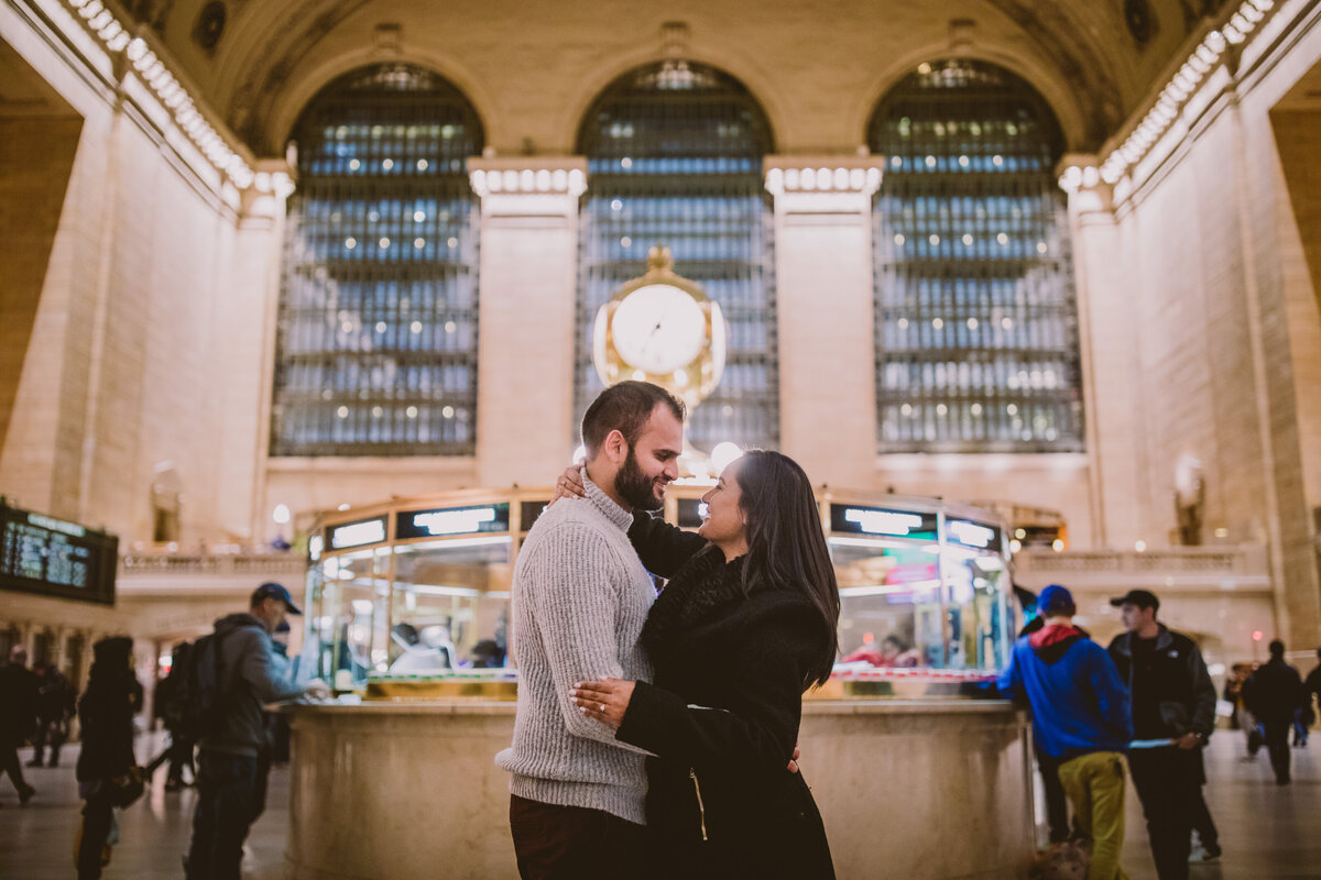 A couple sharing a moment inside the grand central station in nyc in the evening 