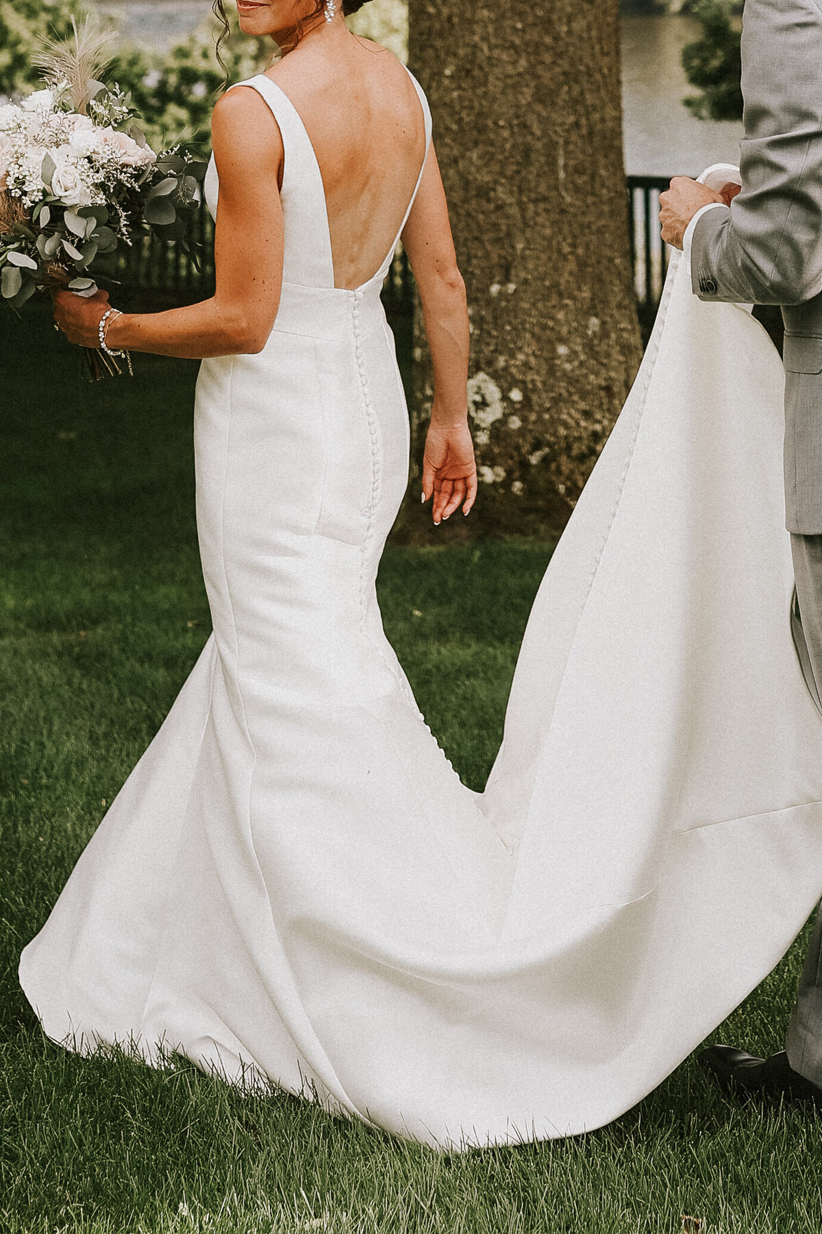 groom-carrying-brides-wedding-dress-train