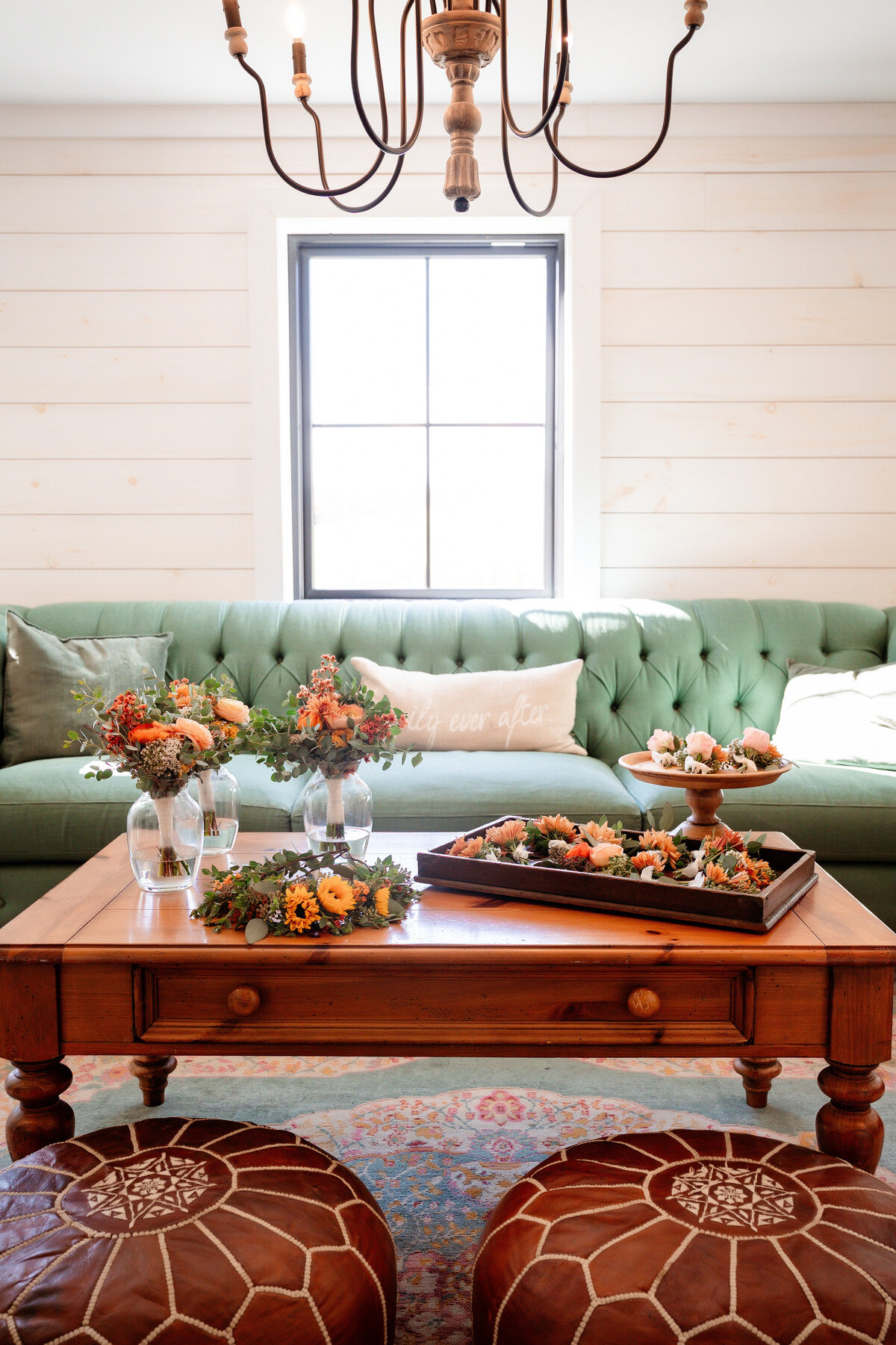 bridal suite at shady elms farm with green sofa and beautiful flowers