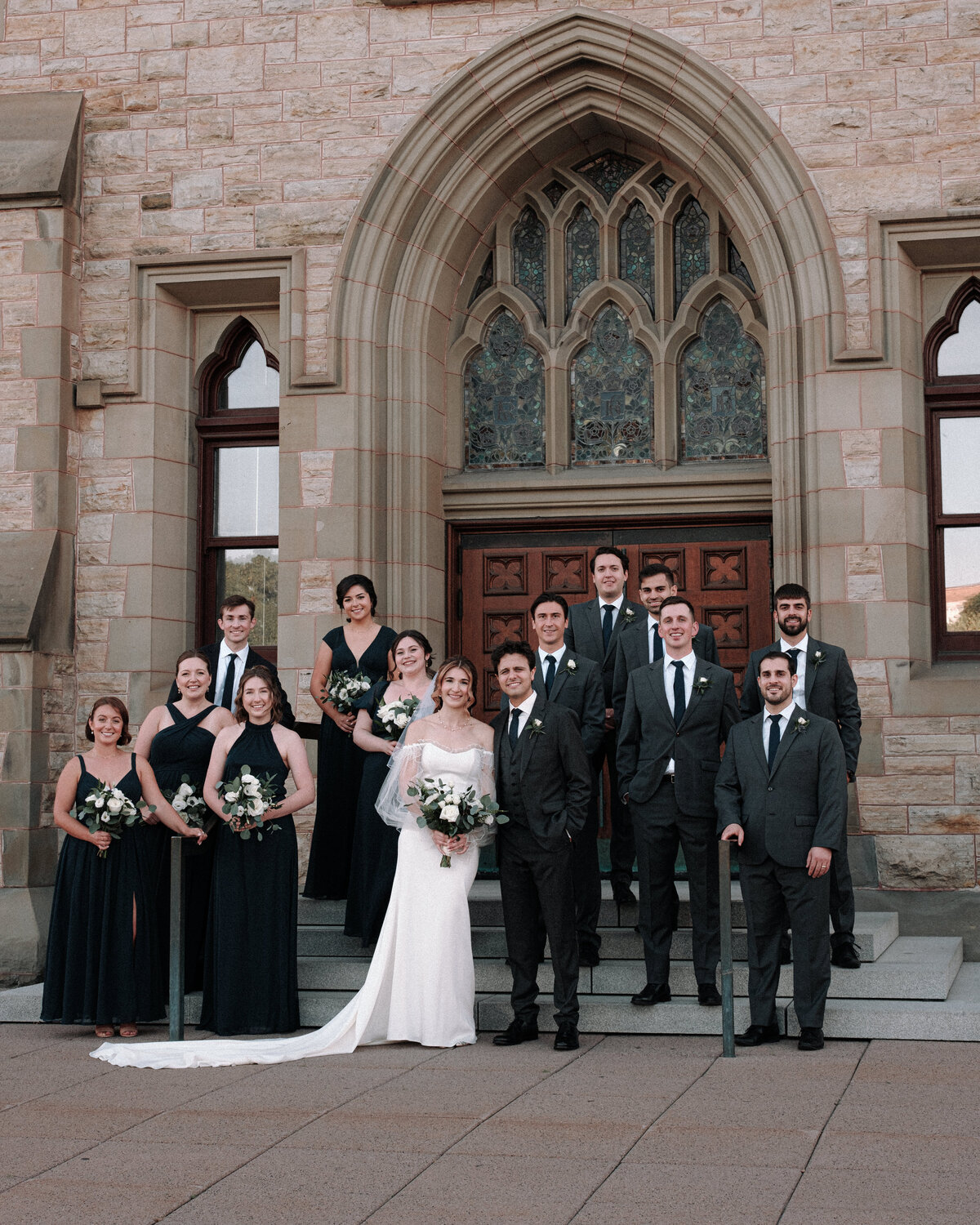 stairwell wedding party portrait in front of musem