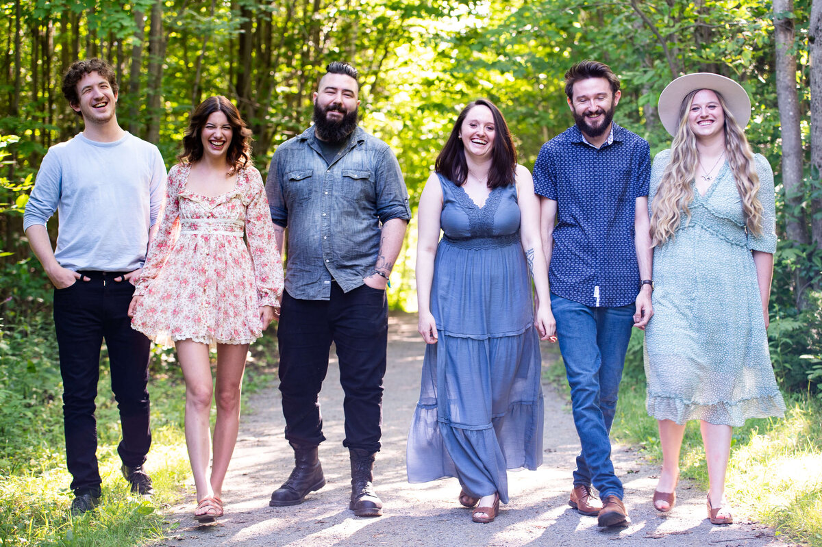 brothers and sisters laughing and walking in the woods captured by Ottawa family photographer JEMMAN Photography
