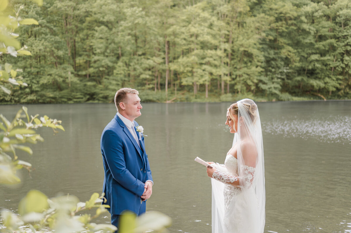 Bride privately reading her vows to groom after their first look, captured by Pittsburgh wedding photographer Bree Stewart of LLP.