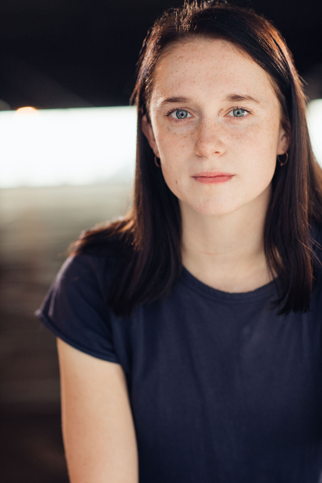 Headshot Photograph Of Young Woman In Dark Blue Shirt Los Angeles
