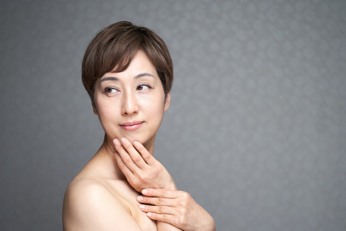 middle-aged-japanese-woman-putting-her-hand-on-her-2023-11-27-04-51-20-utc